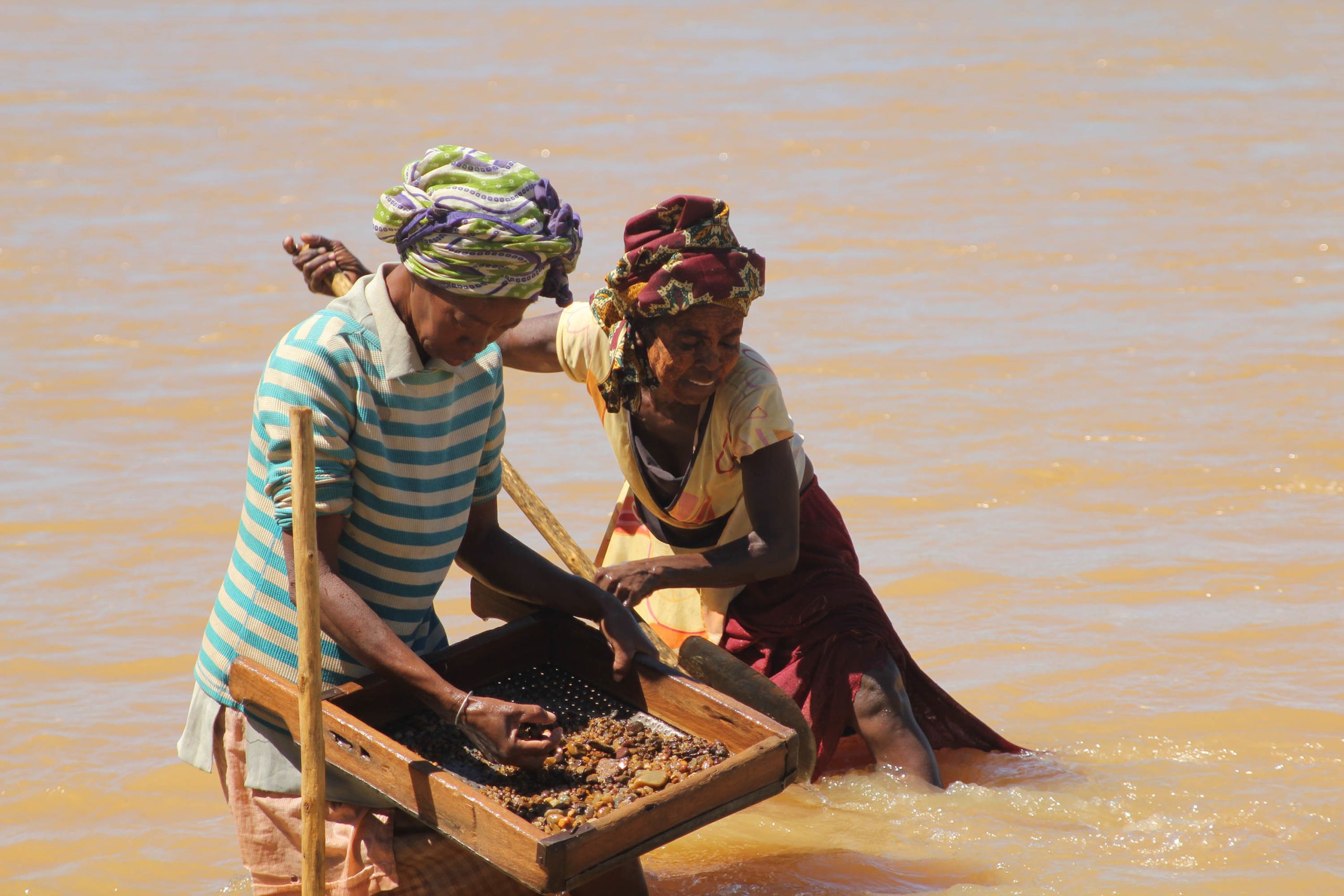 Malagasy women sieving for sapphires