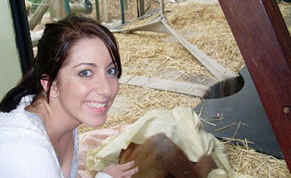 UQ student Danielle Nilsson with an orangutan at Melbourne Zoo