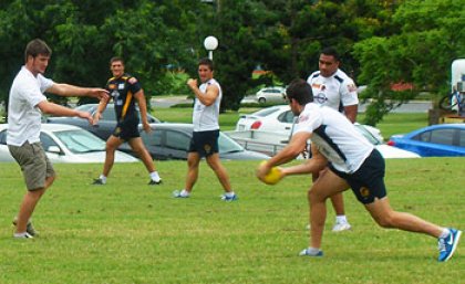 UQ Sport staff enjoy a game of touch football with Brisbane Broncos players