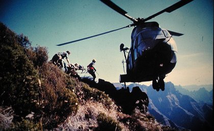 Commander Luckin takes part in a rescue at 10,000 feet in the Drakensberg Mountains, South Africa. With nowhere to land, the pilot has balanced the helicopter on one wheel on a rock