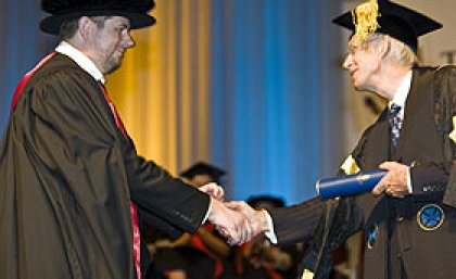 Dr White (left) receiving his PhD from Chancellor Sir Llew Edwards last December