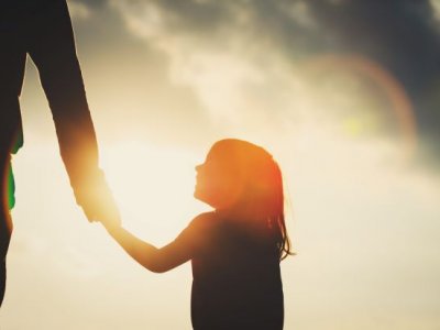 A shadow of a little girl holding a parent's hand