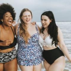 Three women on the beach in their swimwear