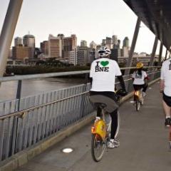 Two cyclists crossing a bridge in Brisbane.