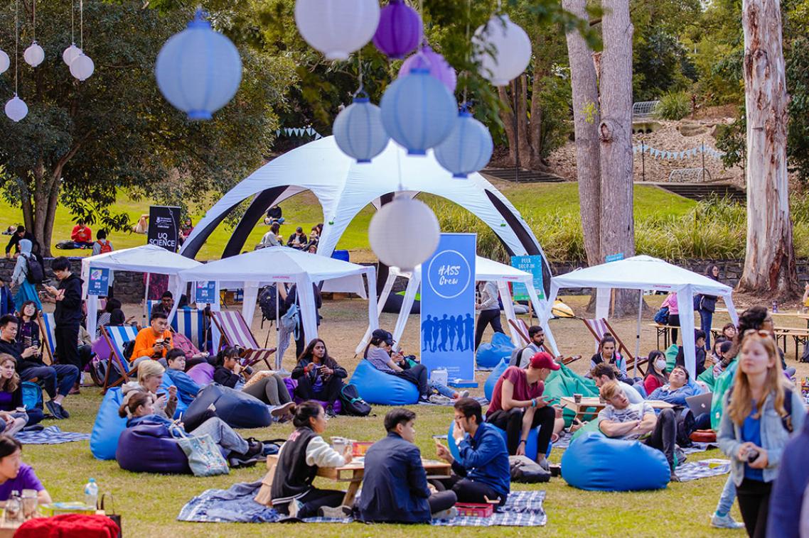 Orientation event with tents and lanterns hanging from trees