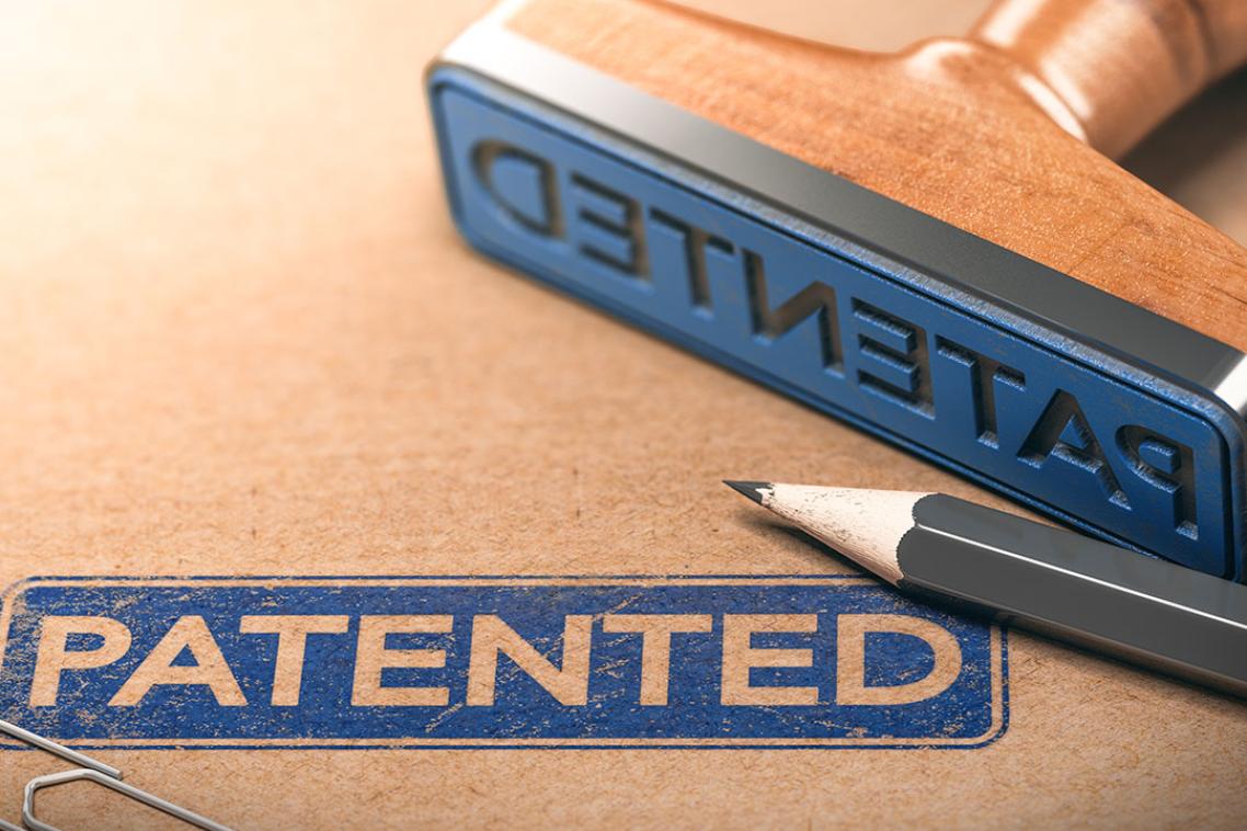 A stamp lying on a piece of paper with the words "Patented" printed
