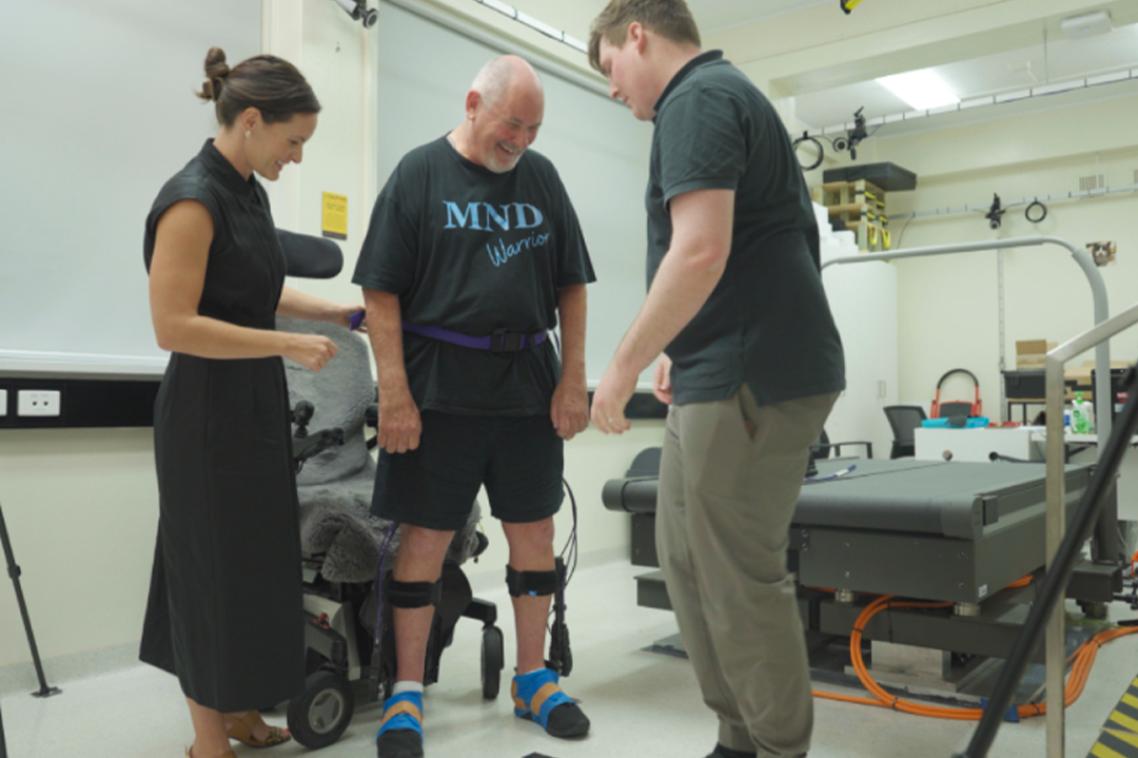Associate Professor Taylor Dick (left) and Dr James Williamson with trial participant Robert Taylor in UQ's Neuromuscular Biomechanics Laboratory.